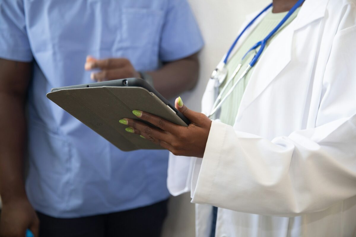 Physician reviewing staff training and delegation protocols in a med spa setting